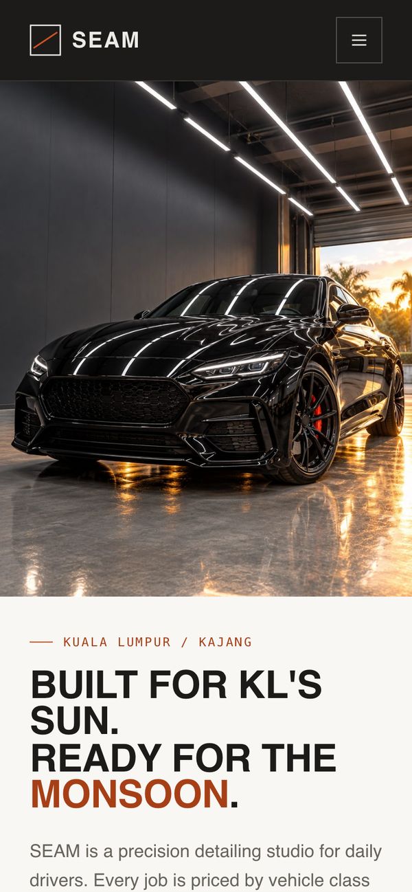 SEAM Detailing on a phone, showing a black car in a lit studio.